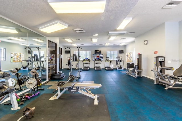 exercise room featuring a textured ceiling