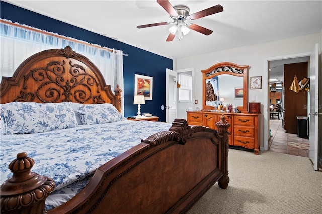 bedroom with ceiling fan and light carpet