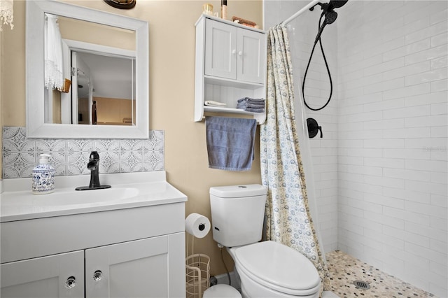 bathroom with decorative backsplash, curtained shower, toilet, and vanity