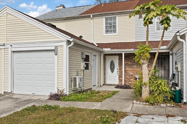 view of front of house featuring ac unit and a garage