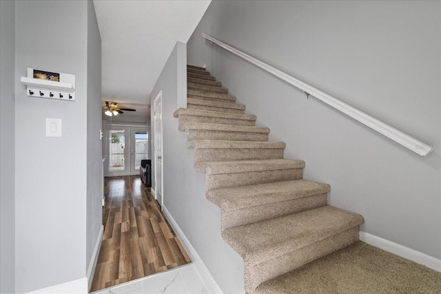 stairway featuring french doors, ceiling fan, and hardwood / wood-style floors