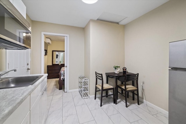 interior space with a wall unit AC and sink