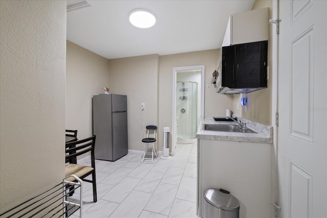 kitchen with stainless steel fridge and sink