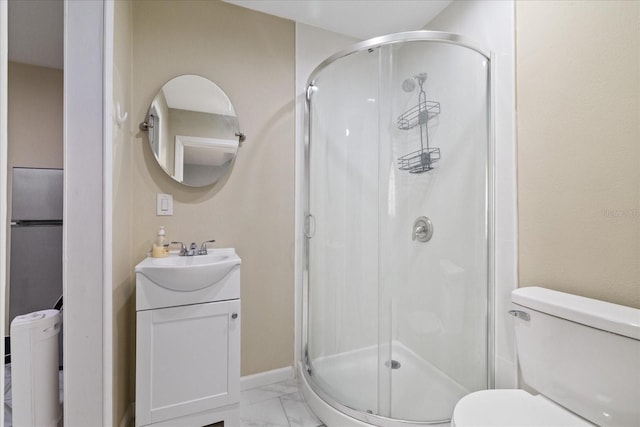 bathroom with vanity, a shower with shower door, and toilet