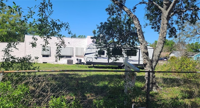 509 Rosery Rd NW, Largo, FL 33770 - exterior space with central AC unit, a yard, and fence