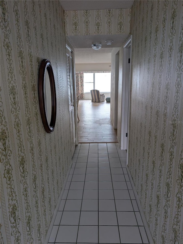 hall with light tile patterned floors