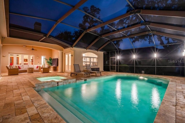 view of swimming pool featuring glass enclosure, ceiling fan, an outdoor hangout area, a patio area, and an in ground hot tub