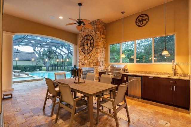 dining room featuring ceiling fan, sink, and a wealth of natural light