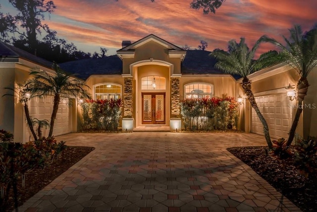 view of front of property with a garage and french doors