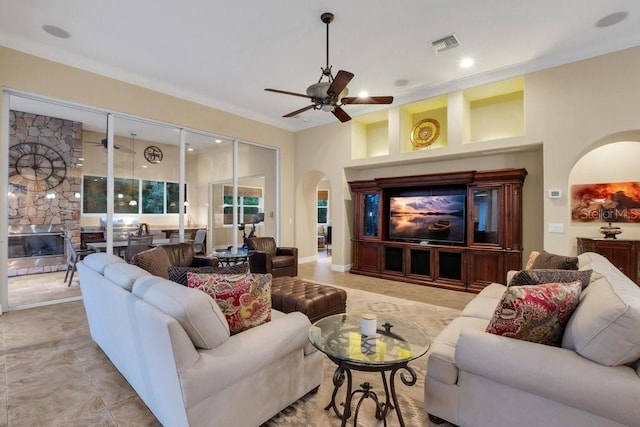 living room with ceiling fan and crown molding