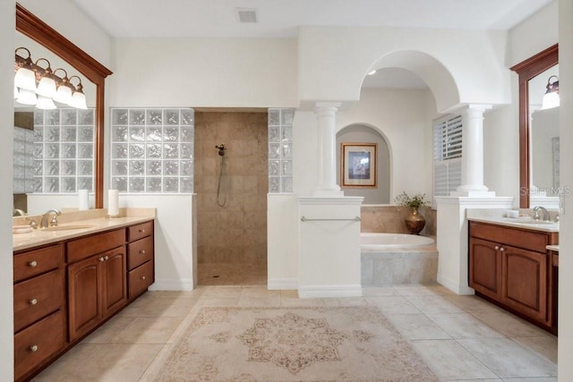 bathroom with tile patterned floors, vanity, and separate shower and tub