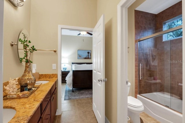 full bathroom featuring shower / bath combination with glass door, tile patterned floors, vanity, and toilet