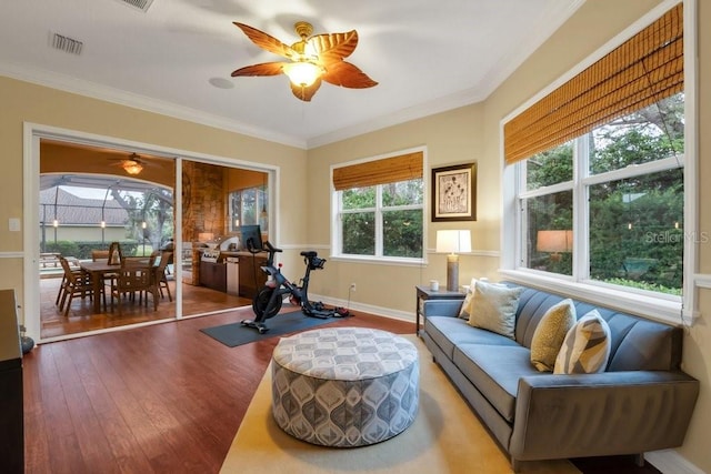 interior space with crown molding, hardwood / wood-style floors, ceiling fan, and a healthy amount of sunlight