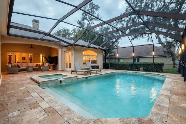 view of pool with a lanai, outdoor lounge area, an in ground hot tub, and a patio