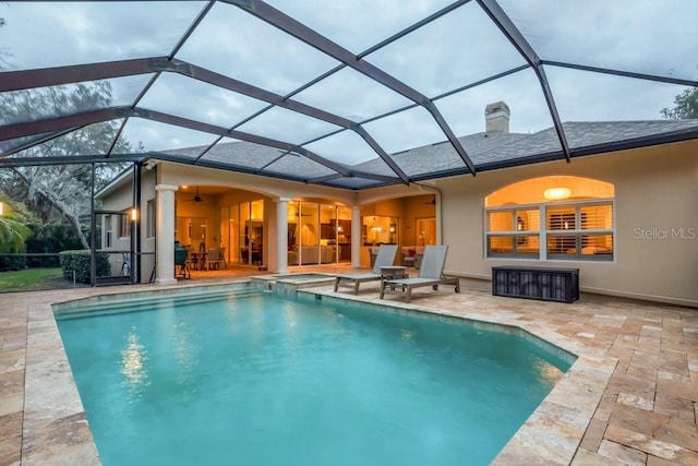 view of swimming pool featuring a lanai, ceiling fan, and a patio