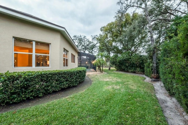 view of yard featuring glass enclosure