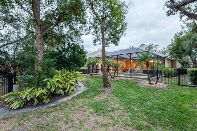 view of yard with a lanai and a fenced in pool