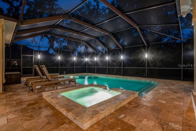 view of swimming pool with a lanai, an in ground hot tub, and a patio