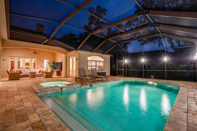 view of swimming pool featuring outdoor lounge area, ceiling fan, a lanai, and a patio