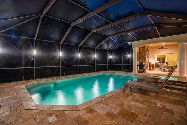 view of pool featuring a patio area, ceiling fan, and glass enclosure