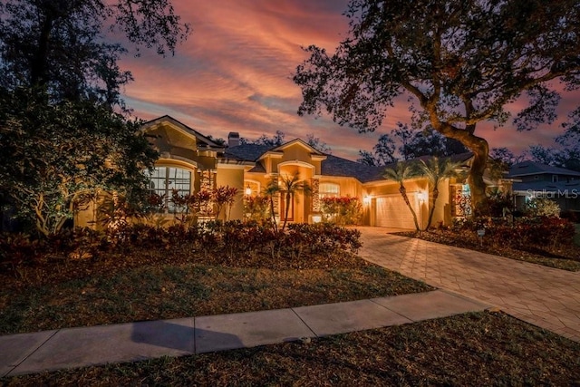 mediterranean / spanish-style home with a garage