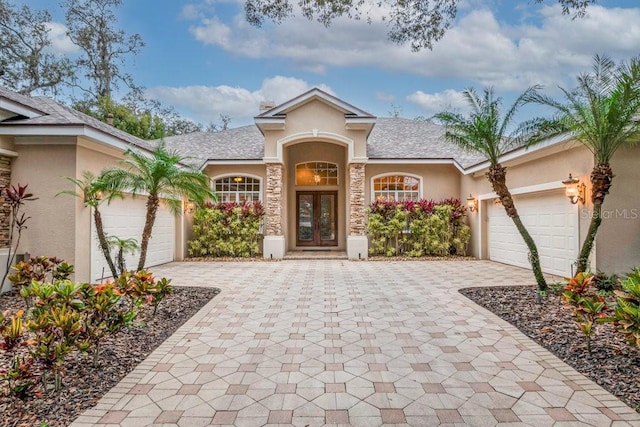 view of front of property featuring french doors and a garage