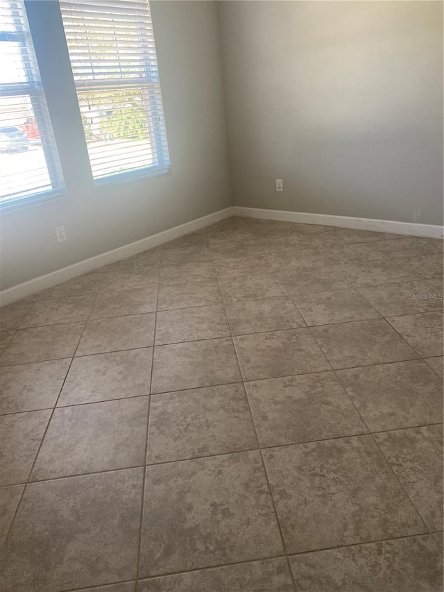 tiled spare room with baseboards