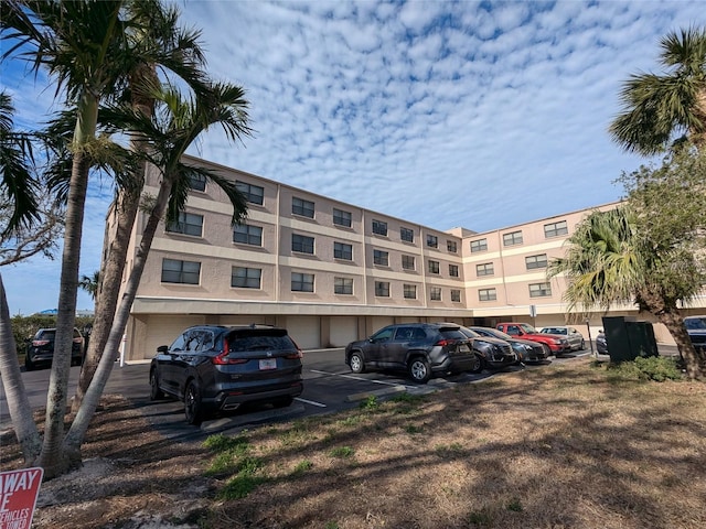 view of building exterior featuring uncovered parking