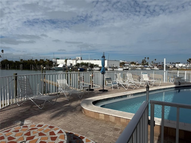 view of swimming pool featuring a water view