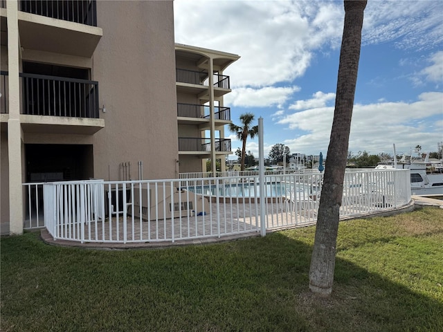 view of swimming pool with a yard and a patio