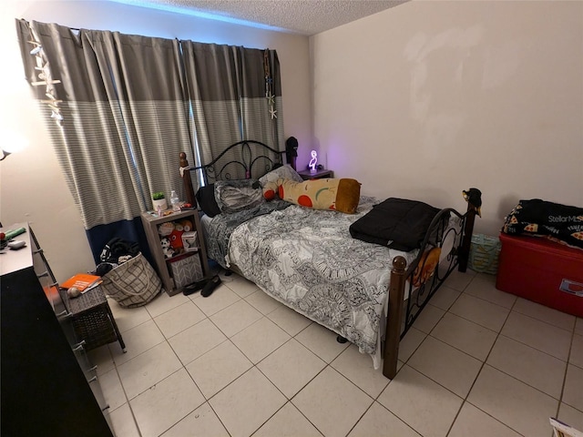 tiled bedroom with a textured ceiling