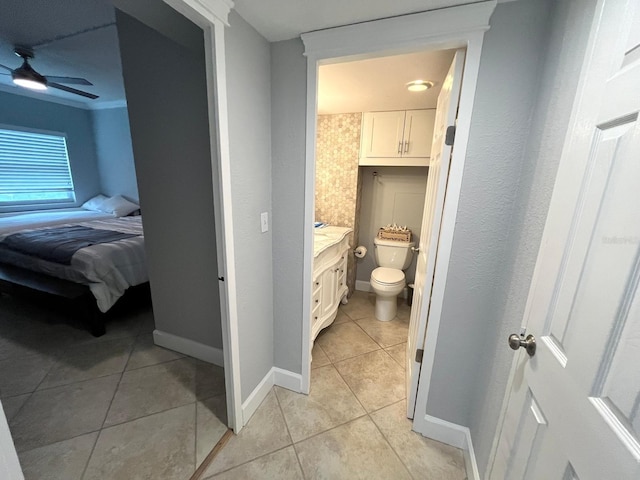 bathroom featuring tile patterned flooring, vanity, toilet, and ceiling fan