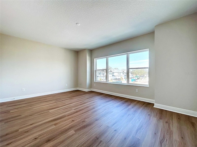 empty room featuring hardwood / wood-style floors and a textured ceiling