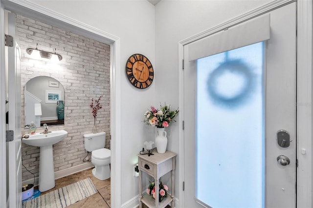 interior space with tile patterned floors, sink, and toilet