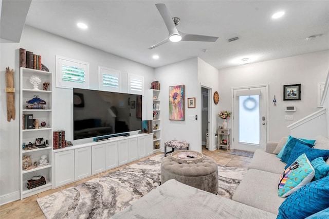 tiled living room with ceiling fan