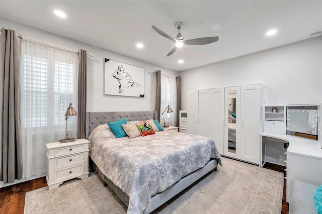 bedroom with ceiling fan and dark hardwood / wood-style floors