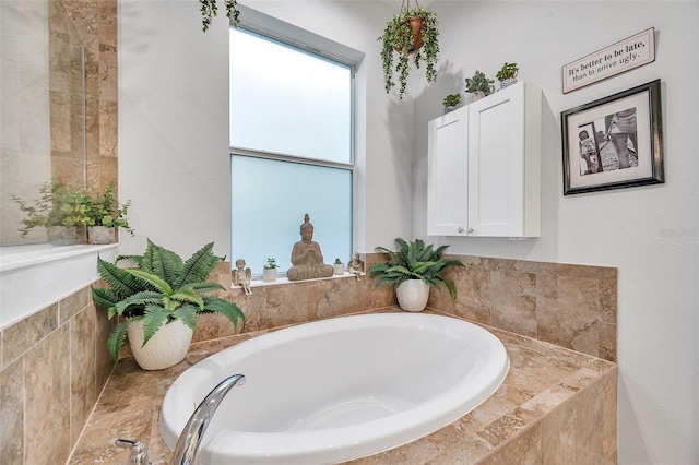 bathroom with a relaxing tiled tub