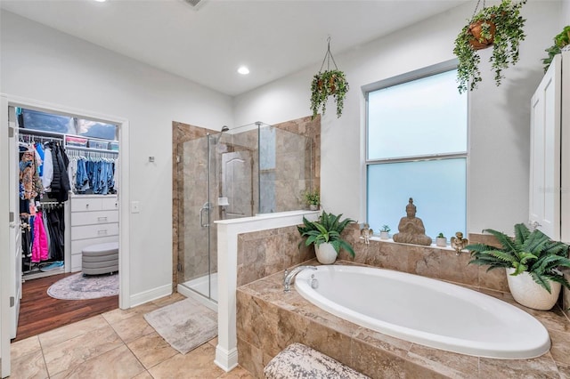 bathroom featuring tile patterned floors and separate shower and tub