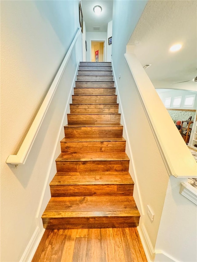 staircase featuring hardwood / wood-style flooring