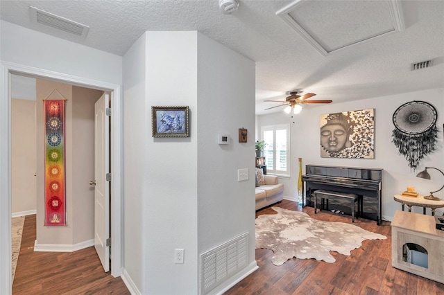 hallway featuring a textured ceiling and dark wood-type flooring