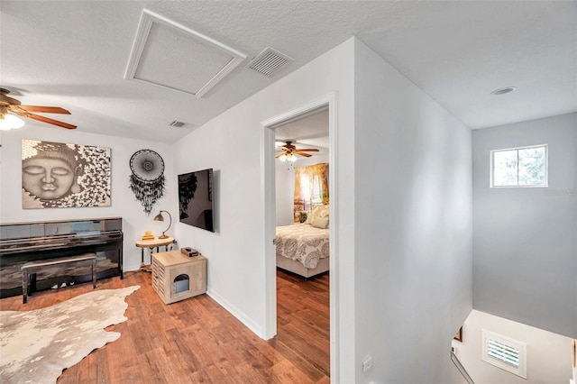 interior space with light wood-type flooring and a textured ceiling