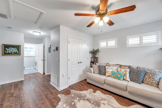 living room featuring a textured ceiling, dark hardwood / wood-style flooring, and ceiling fan