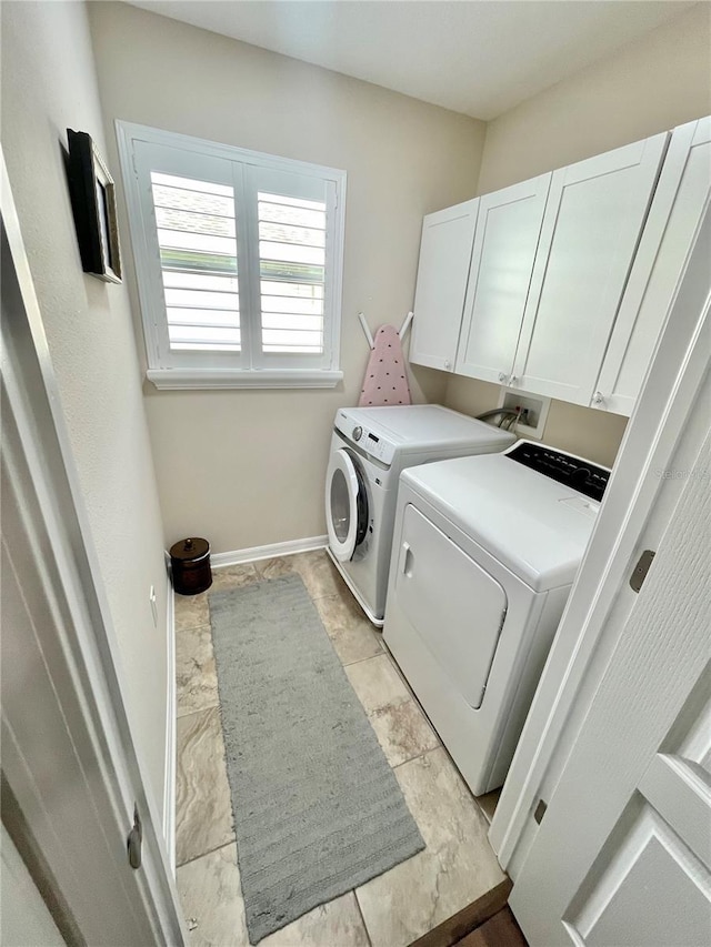 washroom featuring cabinets and washing machine and dryer