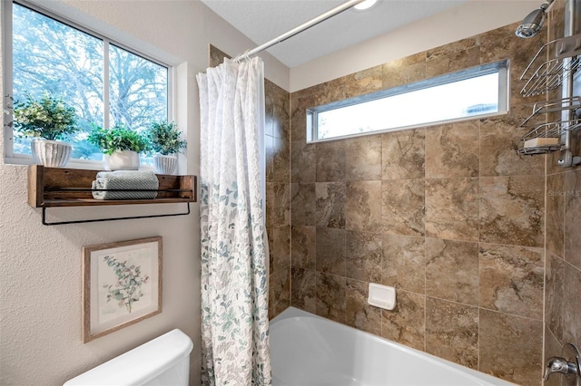 bathroom with shower / bath combination with curtain and toilet