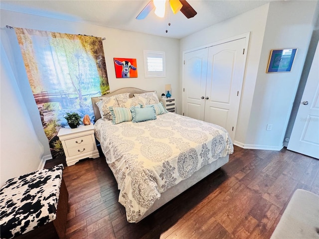 bedroom with dark hardwood / wood-style flooring, ceiling fan, and a closet