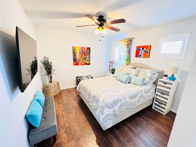 bedroom featuring ceiling fan and dark hardwood / wood-style flooring