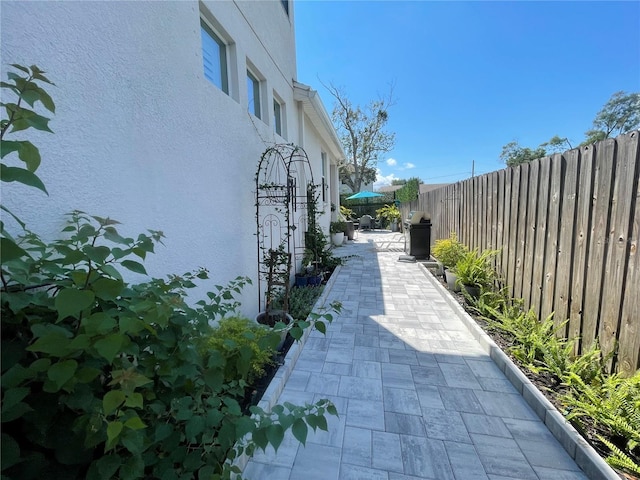 view of side of property featuring a patio area