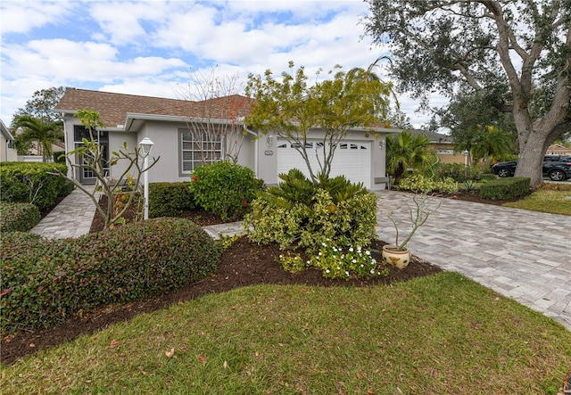 view of front of home with a front yard and a garage