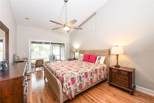 bedroom featuring ceiling fan, lofted ceiling, access to exterior, and light hardwood / wood-style flooring