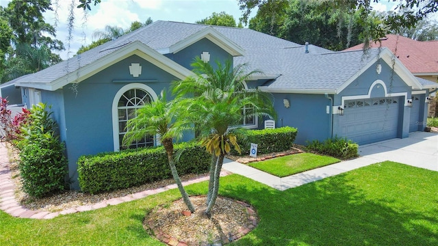 ranch-style house featuring a front yard and a garage